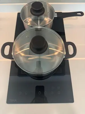 a pot on a stove with two pans on it at Alfa Bangsar By Nova Host in Kuala Lumpur
