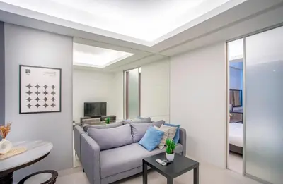 a living room with a couch and a table at Carlton, Chelsea at Plaza Damas 3, Sri Hartamas Kuala Lumpur in Kuala Lumpur