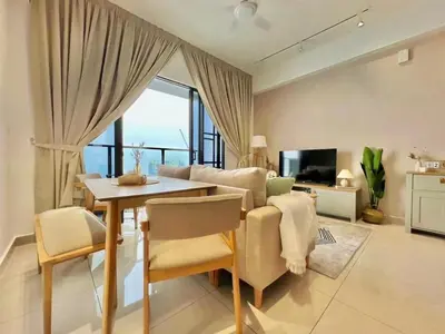 a living room with a table and a dining room at New Luxury 2bed 2bath apartment in Kuala Lumpur