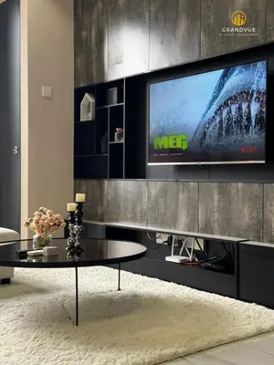 a living room with a tv on a wall at 8 Kia Peng Suites KLCC By HeyStay Management in Kuala Lumpur