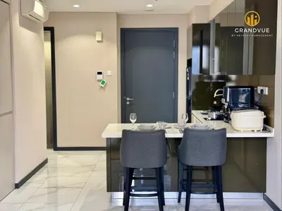 a kitchen with a counter with two bar stools at 8 Kia Peng Suites KLCC By HeyStay Management in Kuala Lumpur