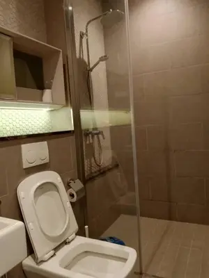 a bathroom with a toilet and a glass shower at Lotus Suite Scarletz KLCC in Kuala Lumpur