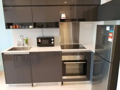 a kitchen with a stove and a microwave at Lotus Suite Scarletz KLCC in Kuala Lumpur