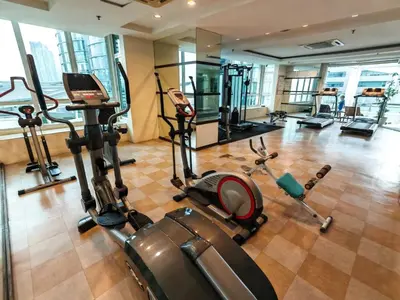 a gym with several treadmills and exercise bikes at Parkview Serviced Apartment in Kuala Lumpur