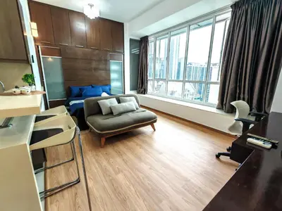 a living room with a couch and a chair at Parkview Serviced Apartment in Kuala Lumpur