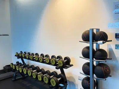 a bunch of dumbbells on a rack in a gym at Eaton KLCC Infinity Pool by NP in Kuala Lumpur
