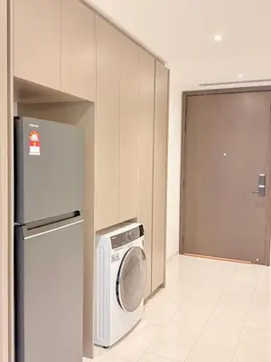 a kitchen with a washing machine and a refrigerator at Eaton KLCC Infinity Pool by NP in Kuala Lumpur