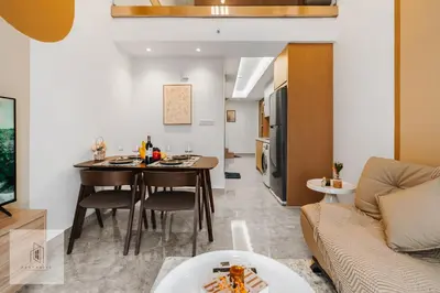 a kitchen and living room with a table and a couch at Agile Bukit Bintang by Fantastic Home in Kuala Lumpur