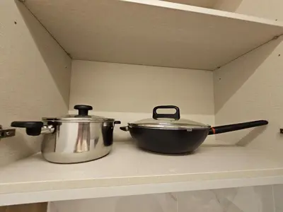 two pots and pans sitting on a shelf in a kitchen at Agile Bukit Bintang by Fantastic Home in Kuala Lumpur