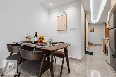 a dining room with a wooden table and chairs at Agile Bukit Bintang by Fantastic Home in Kuala Lumpur