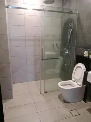 a bathroom with a glass shower and a toilet at OPUS LUXURY INFINiTY POOL KL in Kuala Lumpur