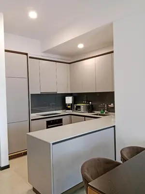a kitchen with white cabinets and a white counter top at OPUS LUXURY INFINiTY POOL KL in Kuala Lumpur