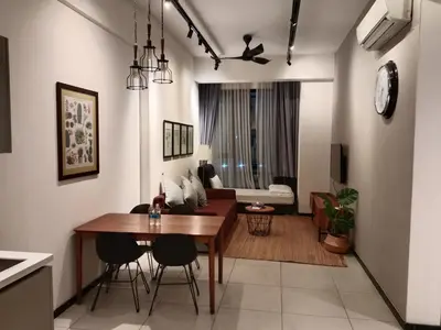 a dining room and living room with a table and chairs at MAXX ROYEL AT OPUS RESiDENCE in Kuala Lumpur