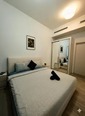 a bedroom with a bed with a black hat on it at M CITY 2 Bed KLCC BY D in Kuala Lumpur