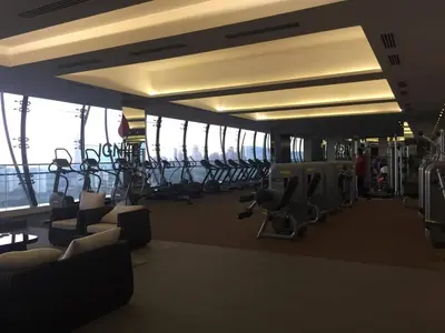 a gym with rows of treadmills and chairs at M CITY 2 Bed KLCC BY D in Kuala Lumpur