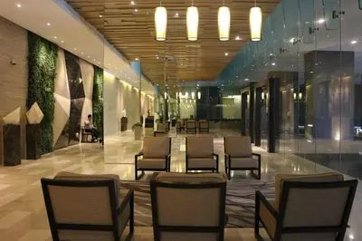 a lobby with chairs and tables in a building at M CITY 2 Bed KLCC BY D in Kuala Lumpur