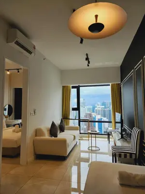 a living room with a couch and a large window at Axon Home Stay by Privet Apartment in Kuala Lumpur