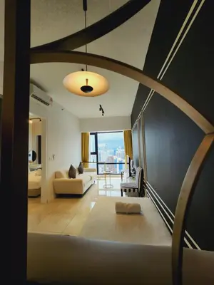 a living room with a couch and a table at Axon Home Stay by Privet Apartment in Kuala Lumpur