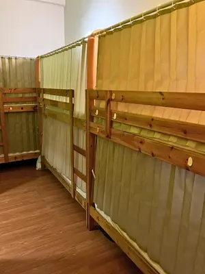 a row of wooden walls in a room at PODs The Backpackers Home & Cafe, Kuala Lumpur in Kuala Lumpur