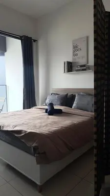 a bedroom with a bed with a blue stuffed animal on it at The Home by Fidi at Continew Residence in Kuala Lumpur