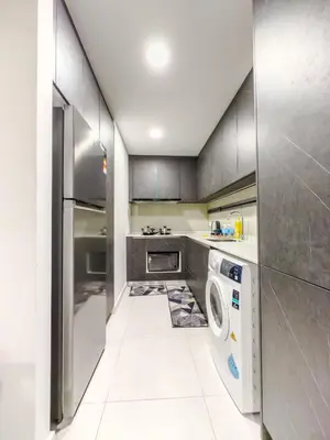 a kitchen with a washer and dryer in it at The Atrium at Jalan Ampang by OKBnB - 3Bedroom Apartment with FREE WiFi & Carpark in Kuala Lumpur