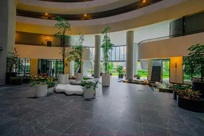 a lobby with potted plants in a building at The Atrium at Jalan Ampang by OKBnB - Beautiful 2Bedroom nearby KLCC in Kuala Lumpur