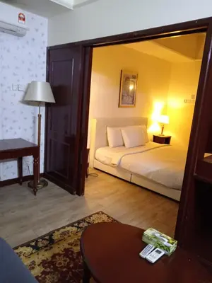 a bedroom with a bed and a table and a mirror at KL Cozy Suite Apartment At Times Square in Kuala Lumpur