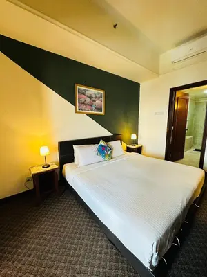 a bedroom with a large white bed in a room at KL Cozy Suite Apartment At Times Square in Kuala Lumpur