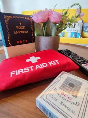 a first aid kit and a book on a desk at KL Midvalley LRT Bangsar Modern BTC12 D in Kuala Lumpur
