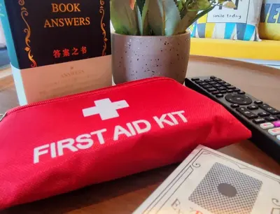 a red first aid napkin next to a remote control at KL Midvalley LRT Bangsar Modern BTC12 D in Kuala Lumpur