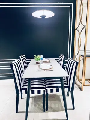 a dining table with two chairs and a table and a light at Axon Residence Bukit Bintang Pavilion KL in Kuala Lumpur
