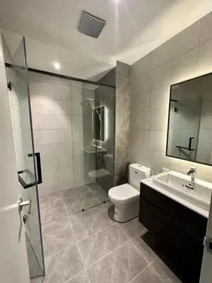 a bathroom with a shower and a toilet and a sink at Axon Residence Bukit Bintang Pavilion KL in Kuala Lumpur
