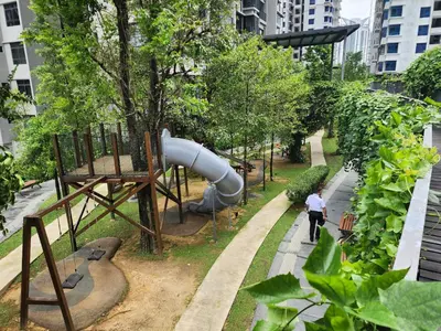 a man walking through a park with a slide at Astoria 4r3b 5minsklcc bathtub waterfilter newcondo bigbalcony in Ampang
