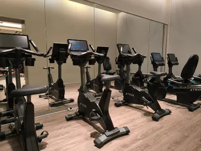 a row of exercise bikes in a gym at Agile Service Suites Bukit Bintang By TRX in Kuala Lumpur