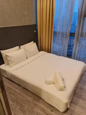 a bed in a room with a large window at THE ROBERSTSON RESIDENT WITH VIEW Kuala Lumpur in Kuala Lumpur