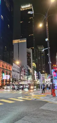 a city street at night with cars and buildings at THE ROBERSTSON RESIDENT WITH VIEW Kuala Lumpur in Kuala Lumpur