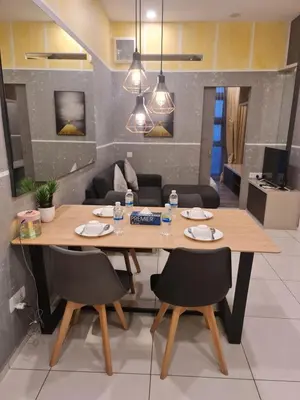 a dining room with a wooden table and chairs at THE ROBERSTSON RESIDENT WITH VIEW Kuala Lumpur in Kuala Lumpur