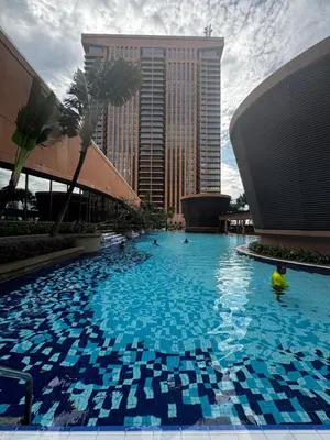 a large swimming pool in a city with buildings at Times Square Service Suites KL, Fortune in Kuala Lumpur