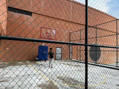 a man is playing basketball in a basketball court at Times Square Service Suites KL, Fortune in Kuala Lumpur