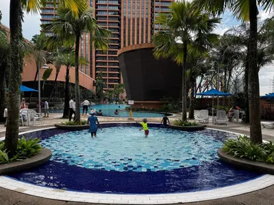 a group of people playing in a large swimming pool at Times Square Service Suites KL, Fortune in Kuala Lumpur