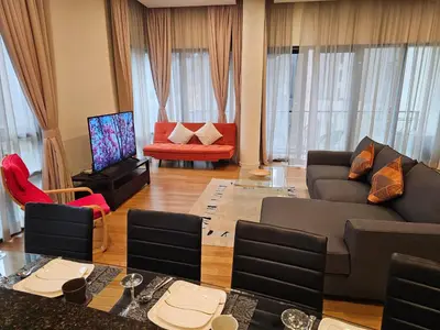 a living room with a couch and a tv at Urban Oasis at St Mary klcc 1Bed2bath in Kuala Lumpur