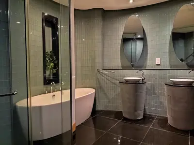 a bathroom with a tub and a sink and two mirrors at Urban Oasis at St Mary klcc 1Bed2bath in Kuala Lumpur