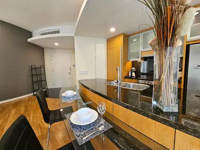 a kitchen with a table and chairs and a vase at Urban Oasis at St Mary klcc 1Bed2bath in Kuala Lumpur