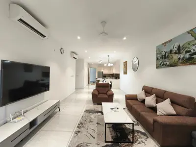a living room with two couches and a large tv at Quill Residences KLCC, Fortune in Kuala Lumpur