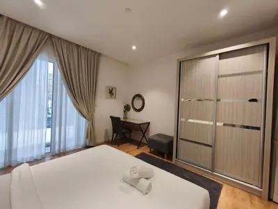 a bedroom with a bed and a sliding glass door at Quill Residences KLCC, Fortune in Kuala Lumpur