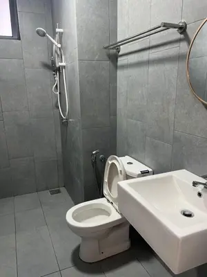 a bathroom with a white toilet and a sink at The E48-10 Stay in Kuala Lumpur