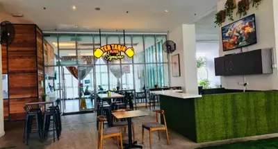 a restaurant with a bar with chairs and tables at Regalia Skypool KLCC Dorms By Tasrifa in Kuala Lumpur