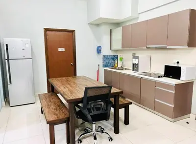 a kitchen with a wooden table and a black chair at Regalia Skypool KLCC Dorms By Tasrifa in Kuala Lumpur