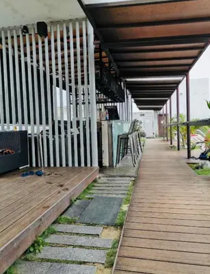 a wooden porch with a bench on a boardwalk at Regalia Skypool KLCC Dorms By Tasrifa in Kuala Lumpur