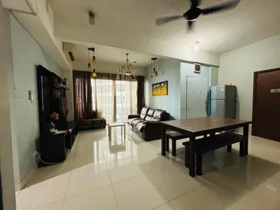 a living room with a table and a couch at Regalia Skypool KLCC Dorms By Tasrifa in Kuala Lumpur